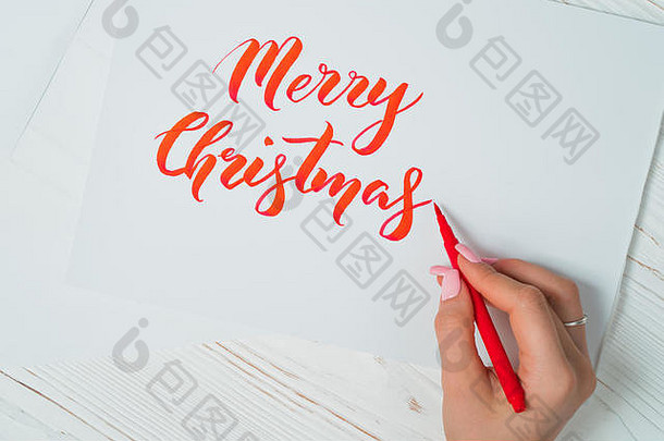 快乐圣诞节祝贺你书法家写红色的墨水白色卡书法点缀字体。艺术刻字图形设计他