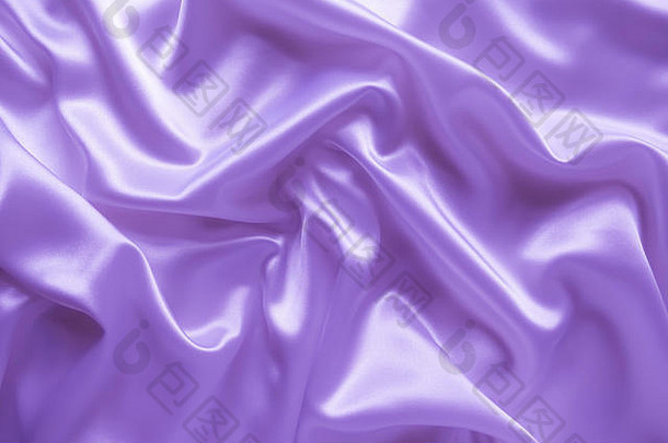 光滑的优雅的波浪紫色的紫罗兰色的缎丝绸奢侈品布织物纹理摘要背景设计