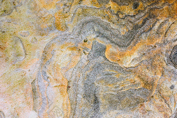 橙色黄色的黑暗灰色沉积岩石色彩鲜艳的岩石层形成胶结沉积摘要图形设计背景