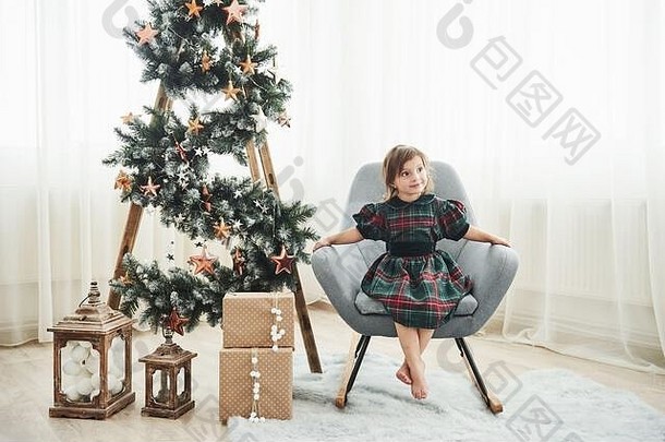圣诞节假期概念可爱<strong>的</strong>女孩坐在椅子梯装饰星星礼物盒子地板上