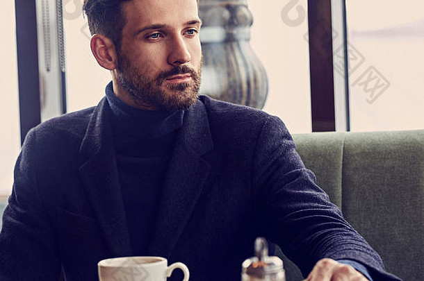 思考英俊的男人。坐着咖啡馆喝杯咖啡早餐特写镜头健美的颜色肖像