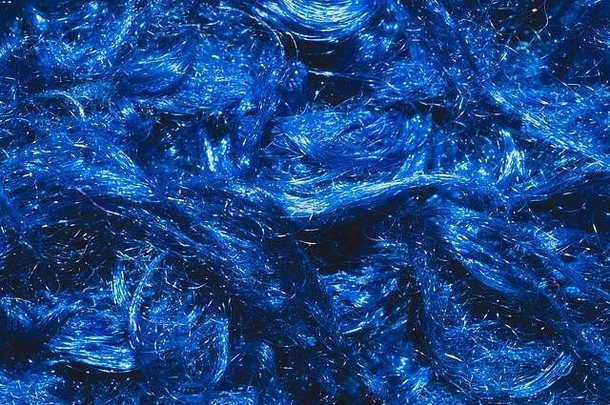 软织物纹理蓝色的纺织卷曲的纤维羊毛背景关闭