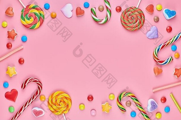 甜蜜的糖果复制空间框架棒棒糖粉红色的背景爱色彩斑斓的甜品童年概念