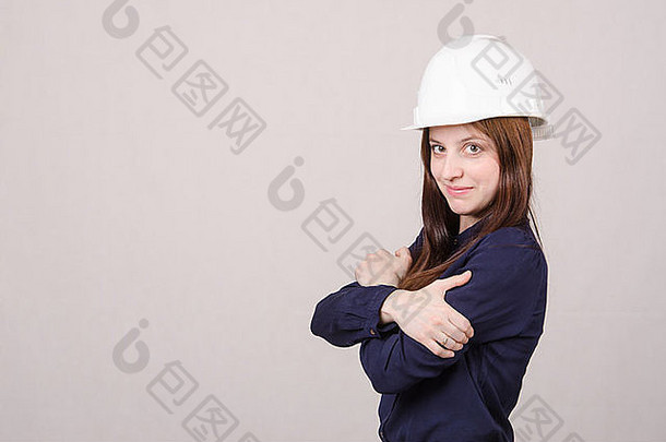 肖像年轻的美丽的女孩工程师架构师头盔