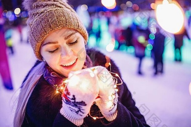 美丽的女人温暖的服装圣诞节晚上照明背景喝热加香料的热酒