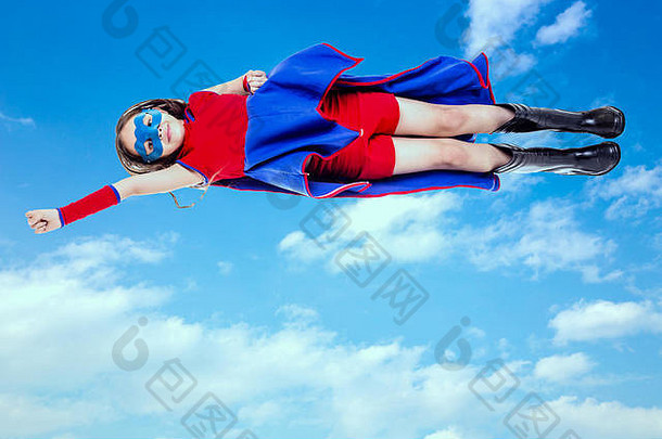 女孩蓝色的红色的超级英雄服装飞行蓝色的天空