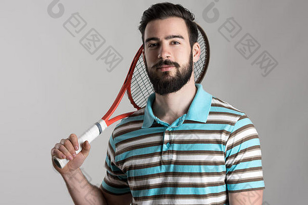 自信年轻的网球球员马球衬衫持有球拍肩膀