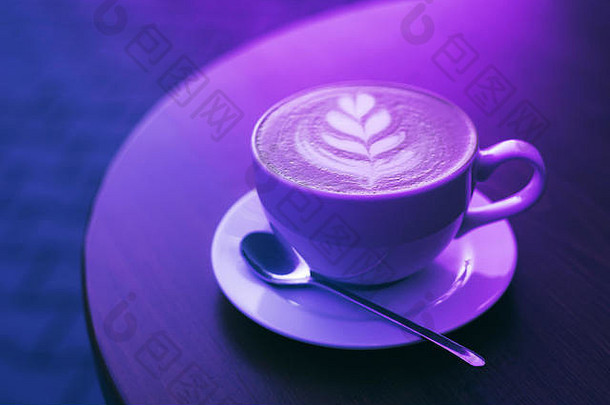 新鲜酿造卡布奇诺咖啡杯白色颜色木表格时尚的霓虹灯光