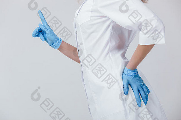 女人医生手医疗乳胶蓝色的手套指出