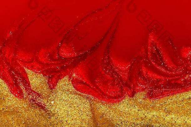 红色的黄金指甲波兰的液体纹理背景