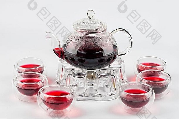 红色的茶茶壶站蜡烛玻璃杯白色背景
