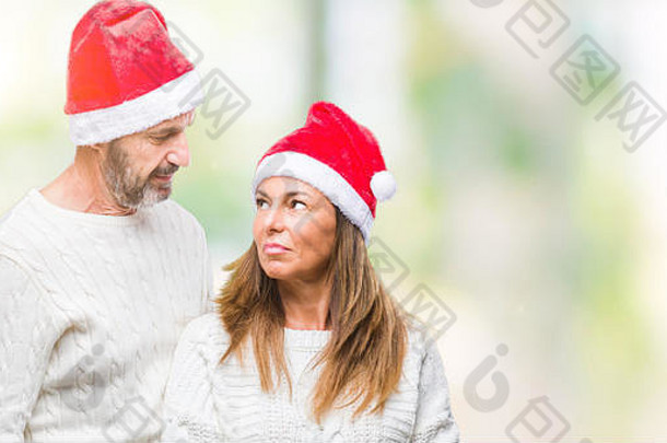 中间年龄拉美裔夫妇穿圣诞节他孤立的背景表达式脸简单的自然相机