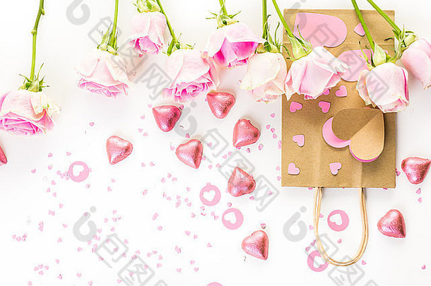 粉红色的玫瑰手精心制作礼物袋白色背景