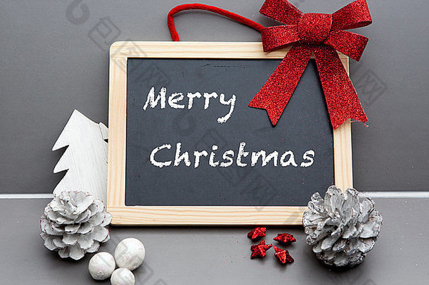 “快乐圣诞节的写黑板上红色的丝带松视锥细胞