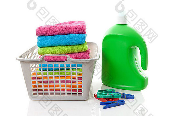洗衣篮子填满色彩斑斓的折叠毛巾挂钩瓶白色背景
