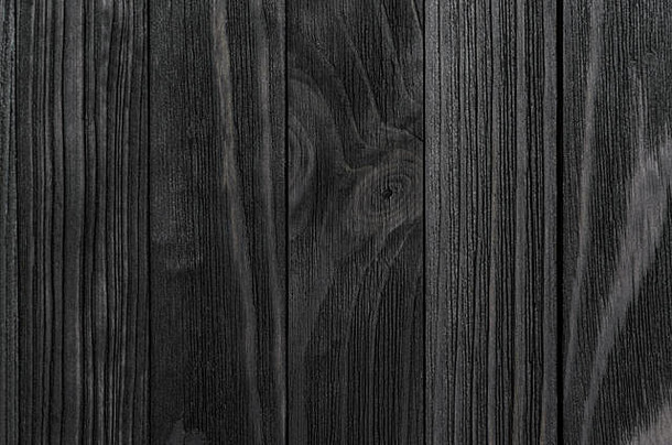 黑色的木纹理黑色的染色木广告牌特写镜头垂直方向有凝聚力的董事会波浪模式木纤维