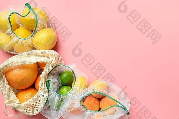 水果柠檬酸可重用的环保网袋粉红色的背景浪费购物
