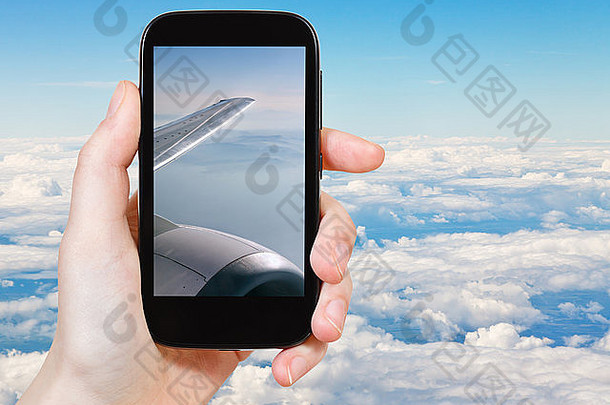 旅行概念旅游采取照片白色云翼飞机移动小工具