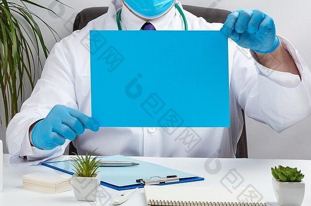 医生白色医疗外套坐着表格棕色（的）皮革椅子持有空蓝色的表纸手的地方inscr