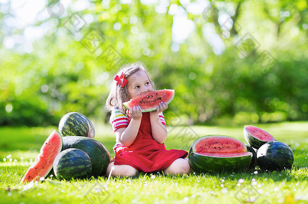 孩子在花园里吃西瓜。孩子们在户外吃水果。儿童健康小吃