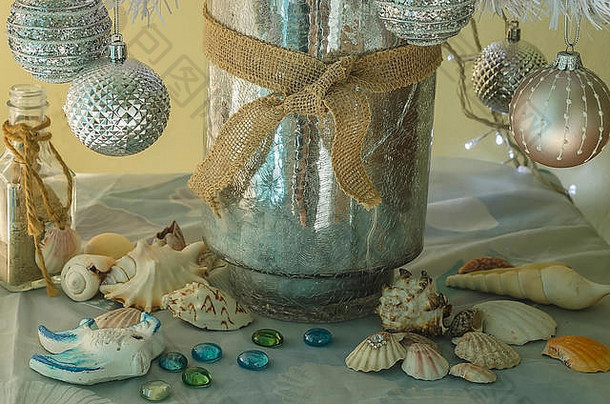 家中的海洋圣诞装饰，有贝壳、蜗牛、网、石头，还有银色和金色的海洋色彩