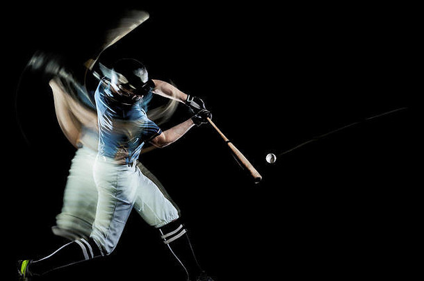 一名白种人棒球运动员在男子工作室拍摄，在黑色背景上进行隔离，并带有光绘速度效果