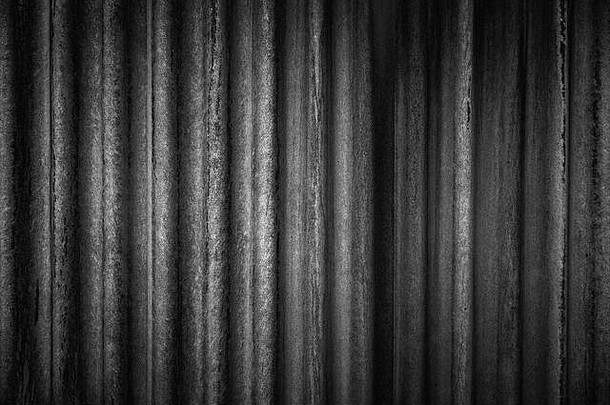 一堵老化、肮脏、有波纹的墙的特写镜头。黑色高分辨率抽象全帧黑白纹理背景。