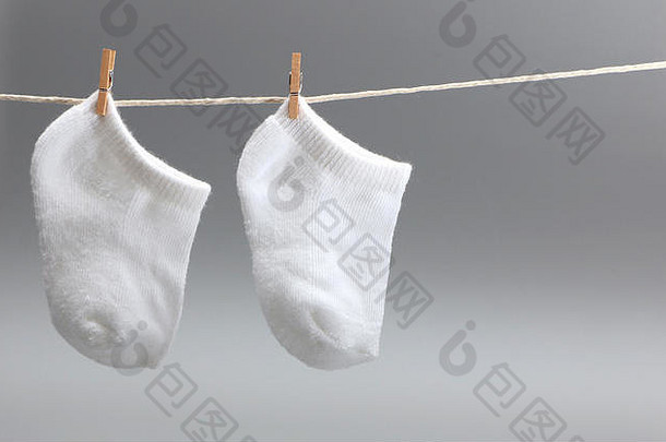 晾衣绳上的一双白色婴儿袜子