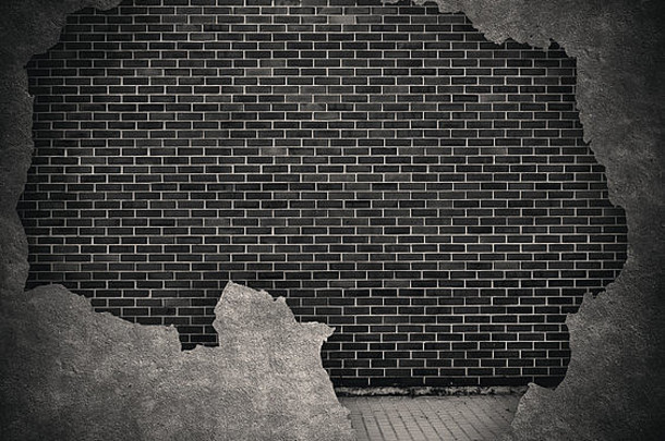 黑色垃圾砖和开裂的混凝土墙背景，带走道
