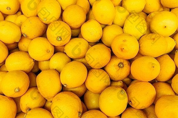 很多成熟的柑橘黄色柠檬可以作为背景