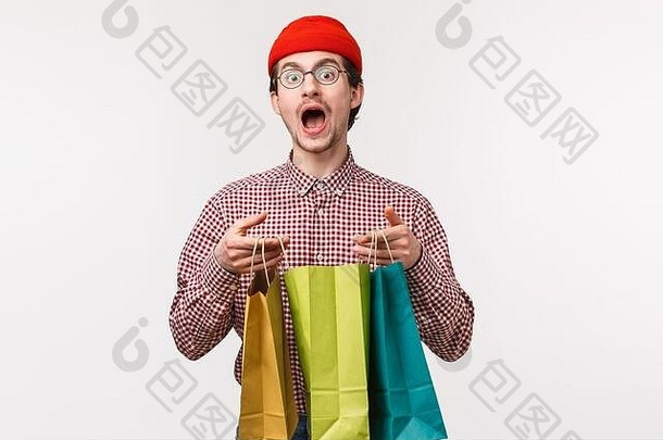 半身照肖像有趣的可爱的高加索人的家伙眼镜红色的无檐小便帽买很多工作人员女朋友希望持有<strong>购物</strong>袋