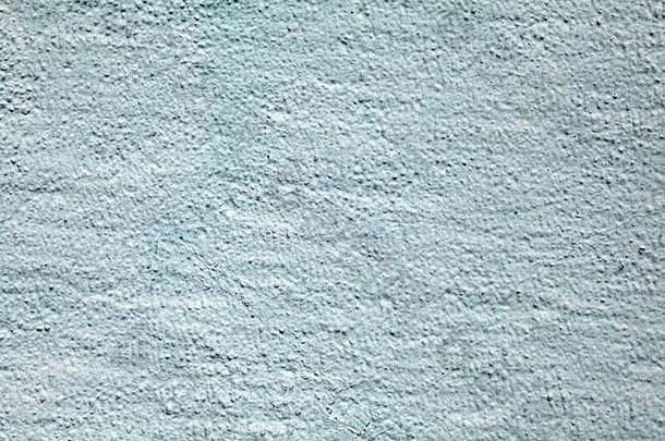 粗糙灰泥墙面的纹理为浅蓝色。抽象背景抹灰表面。