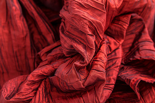 花俏的皱纹红色的织物背景