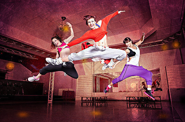 一组穿着运动服的妇女在健身舞蹈练习或有氧运动中跳跃