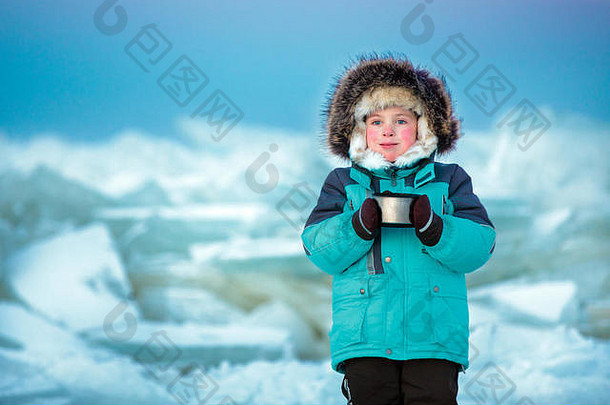 可爱的五岁男孩在冰冷的冬天喝热茶
