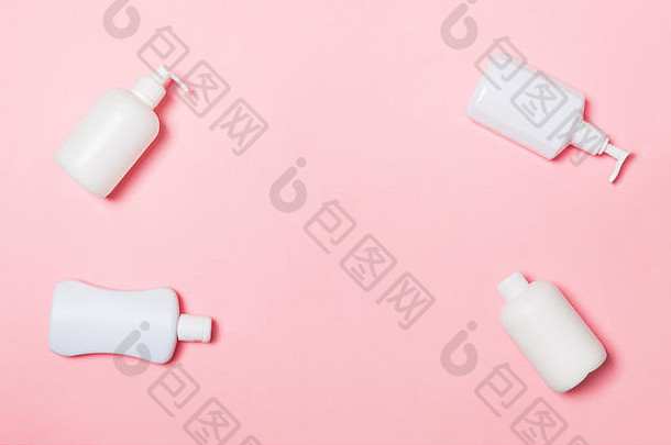 在粉色背景上隔离的一组白色化妆品容器，带有空间的俯视图。一组带有空空间f的塑料保体瓶容器