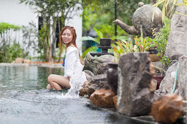 美丽的女人游泳池度假胜地放松年轻的亚洲女孩
