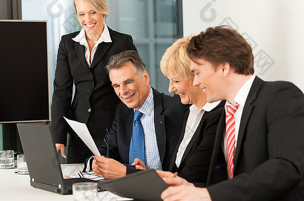 业务团队在办公室用笔记本电脑开会，老板和他的员工在一起