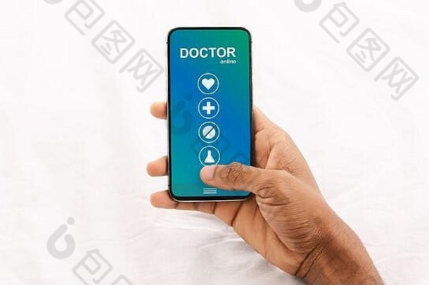 男子手持手机，屏幕上显示在线医疗服务
