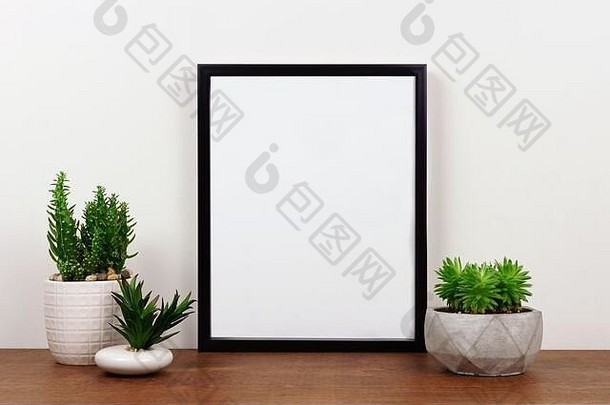 模拟黑色的框架多汁的植物架子上桌子上木架子上白色墙肖像框架取向