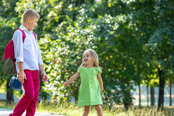快乐笑孩子们玩有趣的公园在户外肖像阳光明媚的夏天一天老哥哥走年轻的妹妹公园