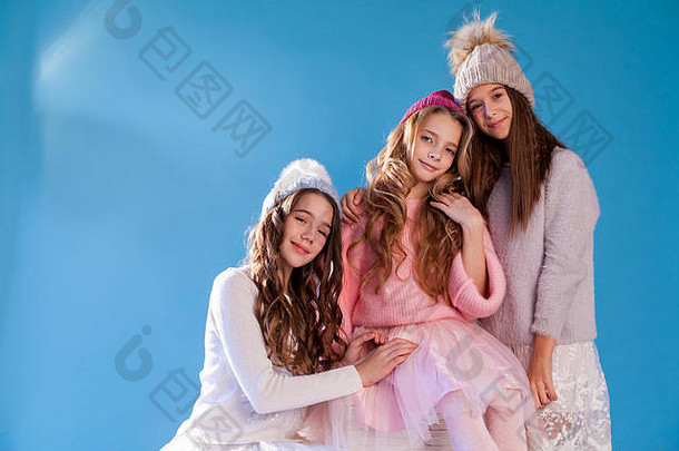 三个穿着冬季针织帽子的时尚女孩女朋友