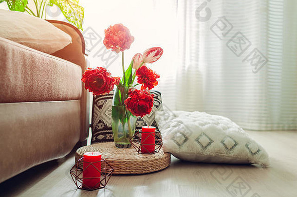 现代客厅内部细节。榻榻米草垫，地板上装饰有鲜花、蜡烛和枕头