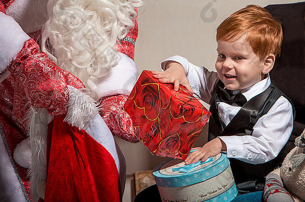 节日与人的概念-带着圣诞老人微笑的小男孩