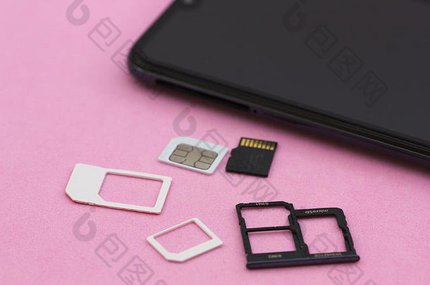黑色的<strong>智能</strong>手机microsd内存卡片是啊卡粉红色的背景