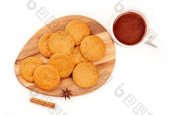 生姜饼干配一杯热巧克力、一根肉桂棒和一颗八角星，从上方拍摄，背景为白色，有复印空间