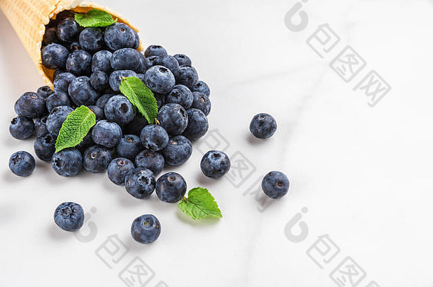 蓝莓薄荷华夫格冰奶油锥白色大理石背景夏天食物概念关闭