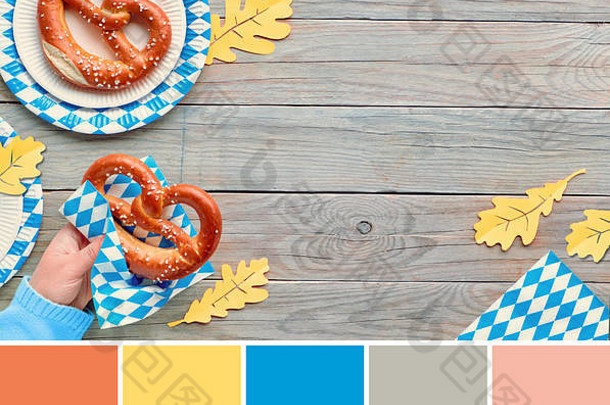 来自啤酒节食品图片的配色调色板，带有手持椒盐卷饼和蓝白装饰