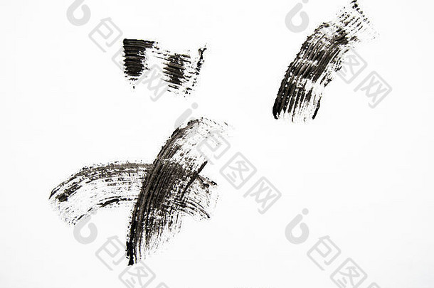 黑色睫毛膏的污迹和质地在白色背景上分离。