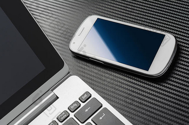 业务工作白色空白智能手机蓝色的反射说谎笔记本键盘碳层
